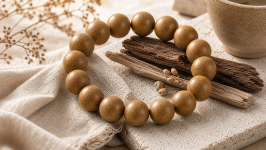 Earth Element aromatic bracelet on stone, linen, clay, and warm neutral materials